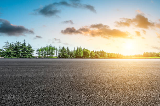 istock Empty asphalt road and green forest landscape 1014496386
