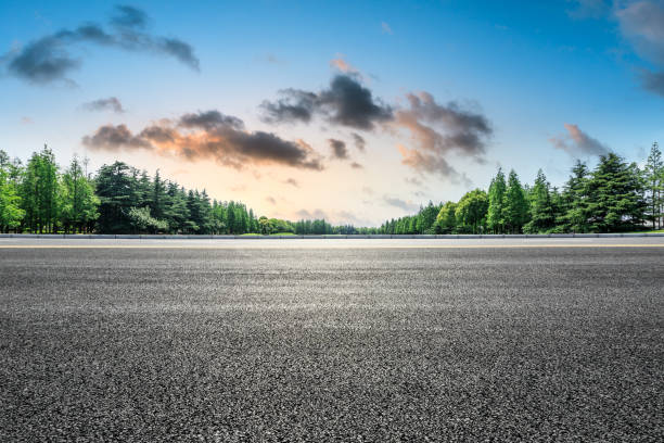 istock Empty asphalt road and green forest landscape 1014496668