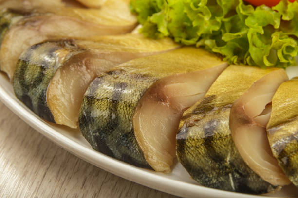 istock Sliced herring on a plate with herbs 1014499436