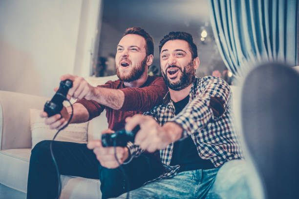 istock Handsome Male Friends Competing On A Video Game Together 1014508904