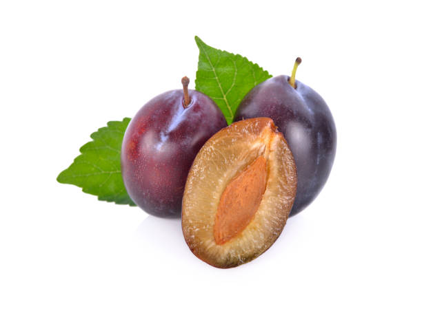 istock whole and half cut fresh prunes with leaf on white background 1014513866