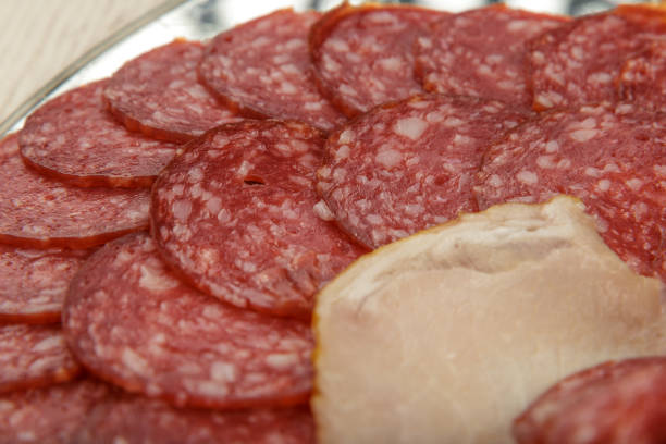 istock Sausage cuts of different varieties on a plate 1014516608