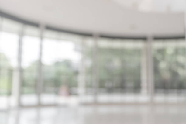 istock Blur background interior view looking out toward to empty office lobby and entrance doors and glass curtain wall 1014519484