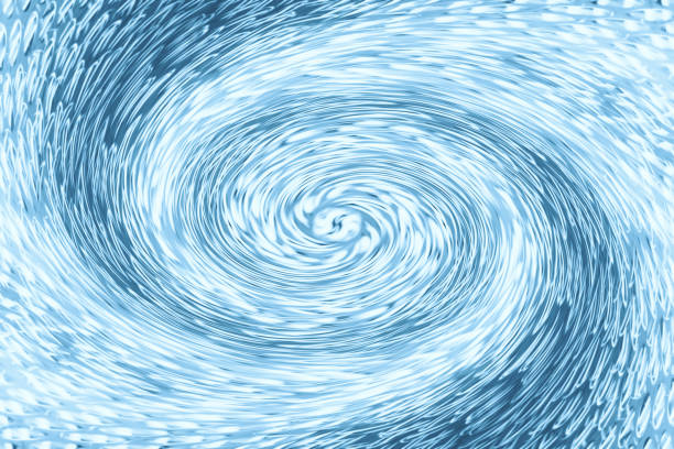 istock Space matter revolves around a spiral wormhole of blue color. Fantastic background image of asymmetric vortex tunnel in center of shot. 1014519712