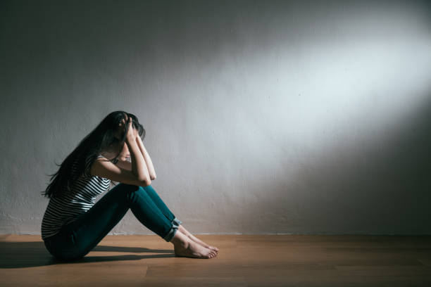 girl having trouble and getting depression illness unhappy beauty girl having bad trouble and getting depression illness sitting on wooden floor daydreaming in white background. bipolar disorder stock pictures, royalty-free photos & images