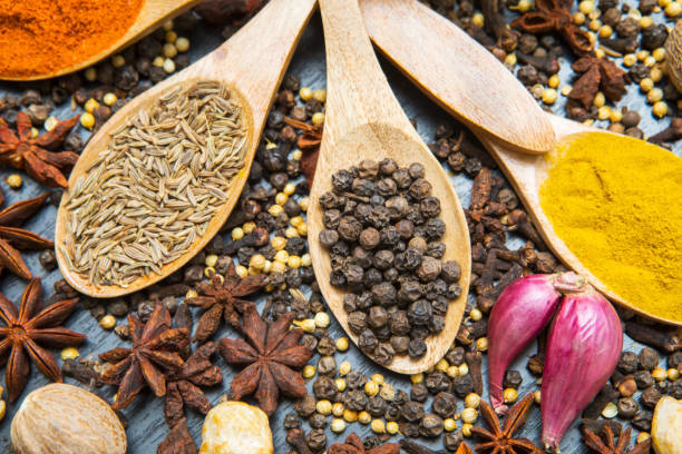 istock Assorted spices with wooden spoons 1014541462