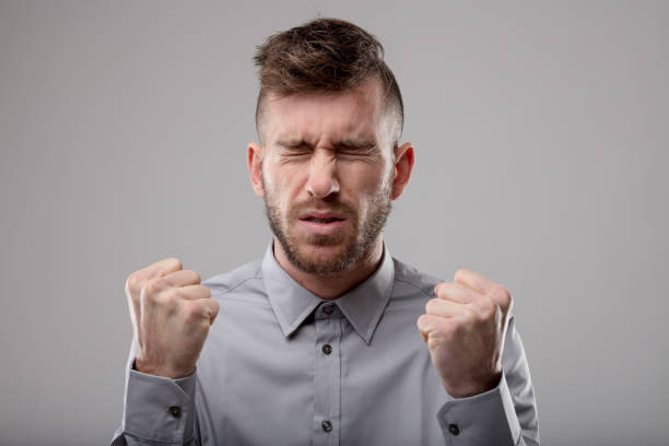 istock Man deep in concentration screwing up his eyes 1014544182
