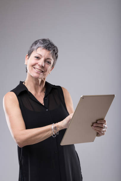 istock Attractive middle-aged businesswoman using tablet 1014544388