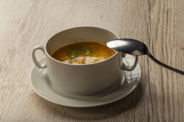 istock Plate with soup and cutlery on a wooden background 1014544464