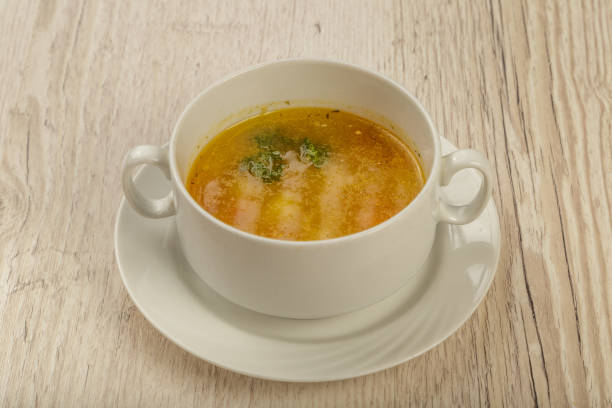istock Plate with soup in a white plate on a wooden background 1014544486