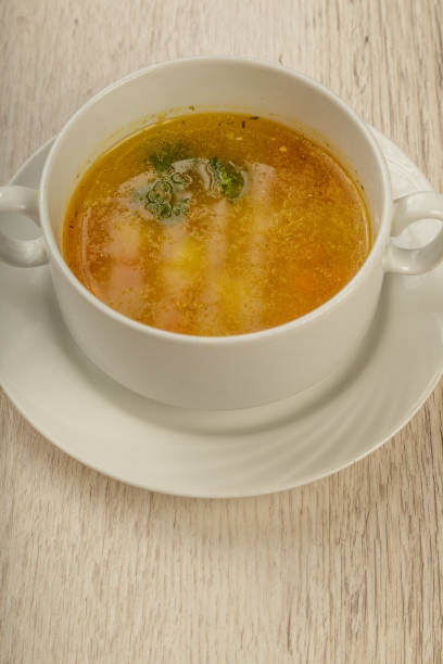 istock Plate with soup in a white plate on a wooden background 1014545792