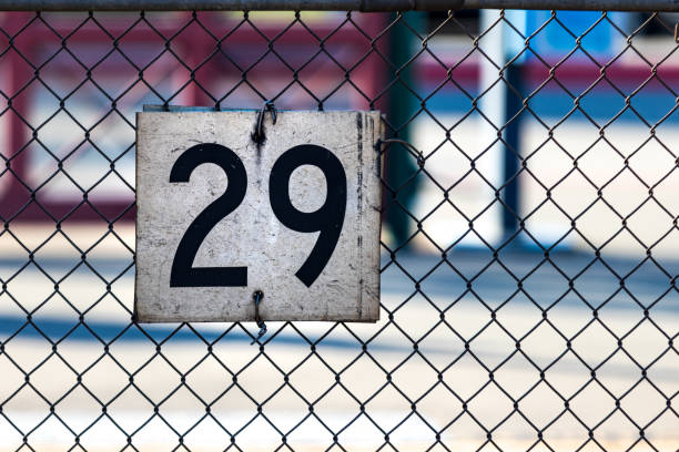 istock white sign on a chain link fence with the number 29 1014546880