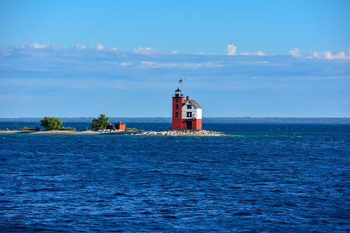 Red and white lighthouse off the coast of mackinaw Island, Michigan. USA, North America. Great Lakes during the summer.