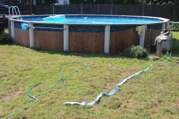 istock Above ground swimming pool with filter and deck 1014552358