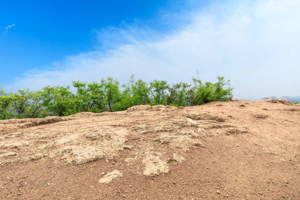 Mountain peak rock road platform and green trees under the blue sky