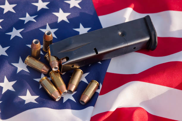 istock A pistol magazine with bullets on an American flag background 1014565986