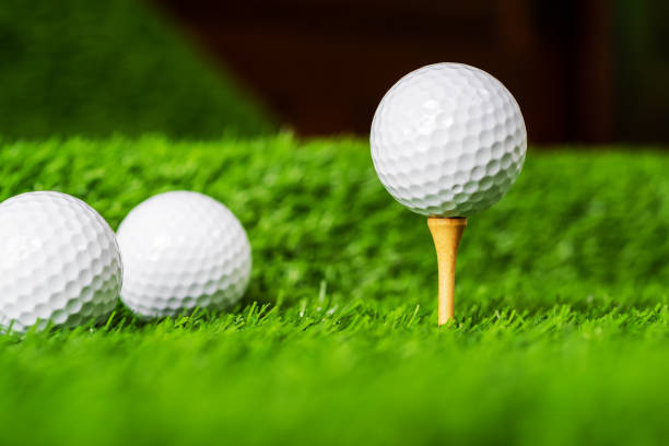 istock Golf ball with green grass background, on tee closeup. 1014576224