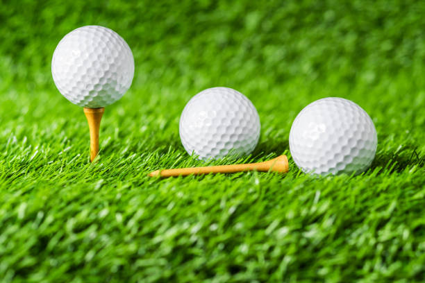 istock Golf ball with green grass background, on tee closeup. 1014576272