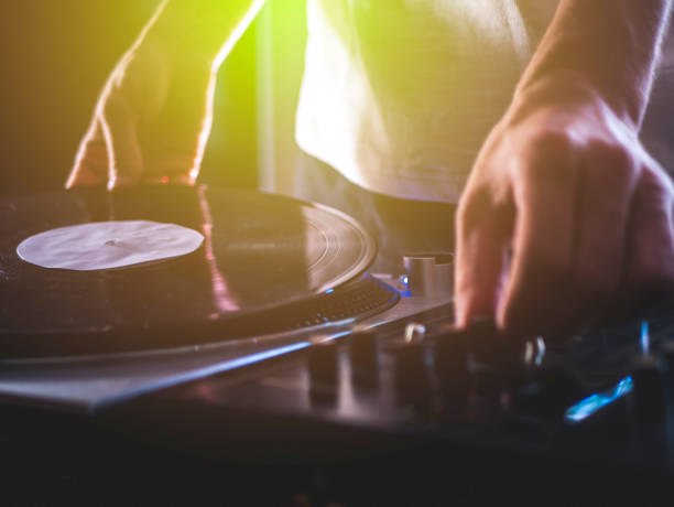 istock dj hands on professional music equipment deck vinyl record turntable and timecode 1014576496