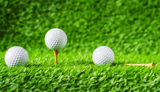 istock Golf ball with green grass background, on tee closeup. 1014576542