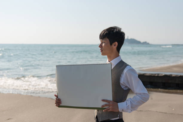istock Businessman showing flip board on beach 1014578784