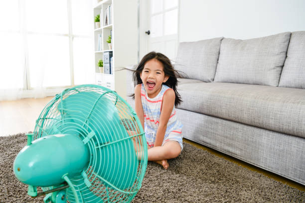 istock happy attractive female kid blowing cooling wind 1014579156