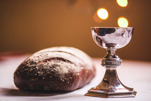 Challis Challis and bread, with blurred background, and lights in the background, christian. anglican stock pictures, royalty-free photos & images
