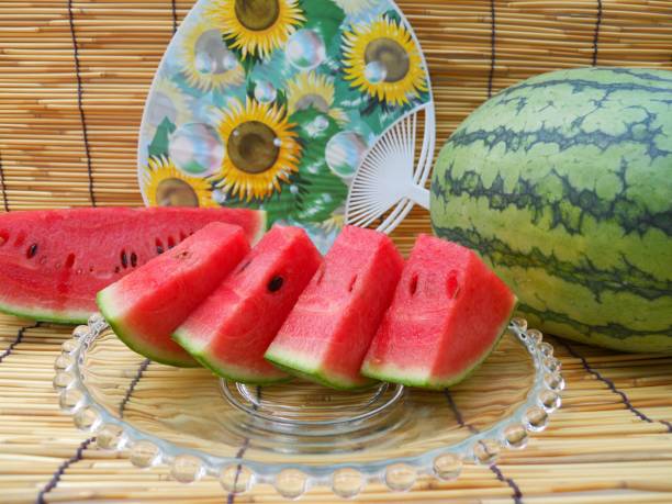 istock Watermelon and round hand fan 1014582306