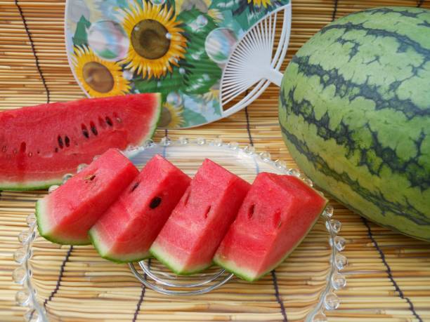 istock Watermelon and round hand fan 1014582358