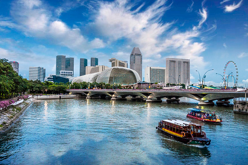 Traditional old style boat in Business district in marina bay Singapore