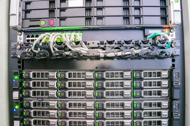 Photo of Modern database servers are connected to the switch in the server room rack. Hosting of popular portals is in the data center. The computer equipment is  on the technical site of the Internet provider