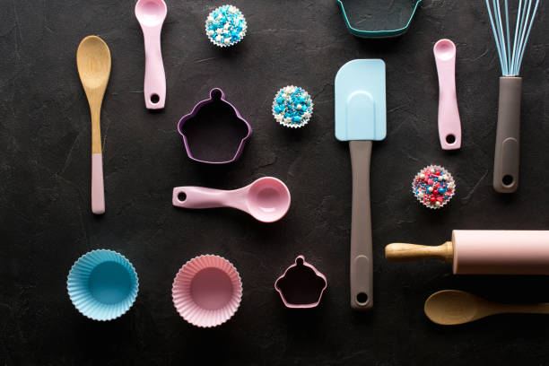 istock Baking and cooking concept. Pattern made of cookie cutters, whisk, roller pin and kitchen bake tools for making sweets. Dark  background. Top view of a holiday baking still life 1014613558