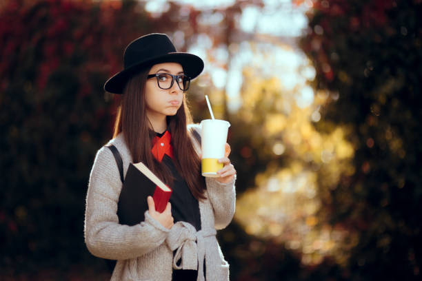 istock Hipster Student Holding a Book Outdoors in Autumn Decor 1014616026