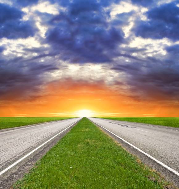 istock two way asphalt road at the sunset 1014632528