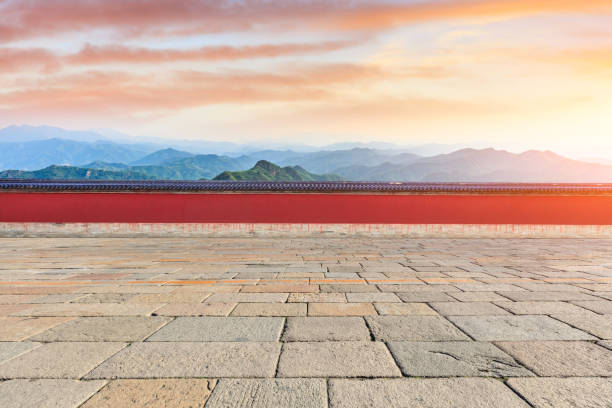 Square brick floor and mountains landscape at sunset
