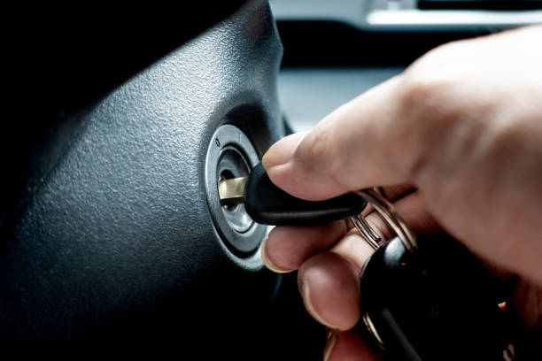 istock Hand turning car key in the key hole to start the car engine 1014655880