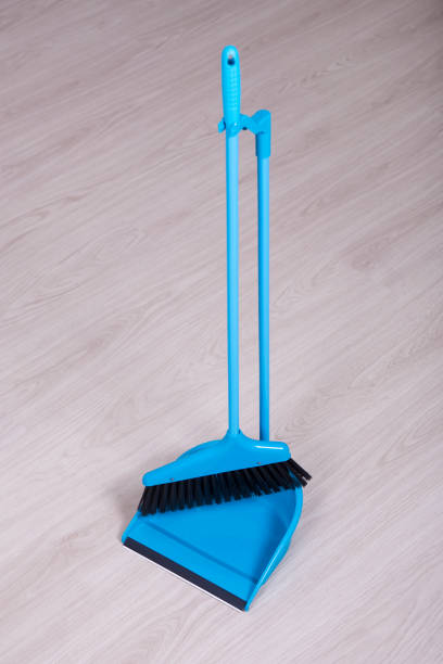 istock scoop and broom over wooden floor background 1014656584