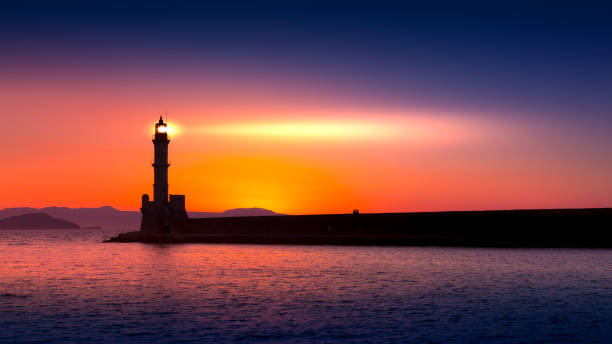 a beautiful night sky behind a shining lighthouse. crete, greece - beacon imagens e fotografias de stock