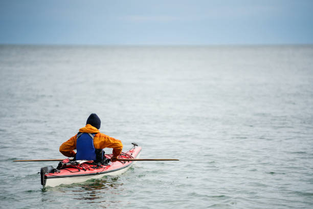 One woman kayaking in the ocean