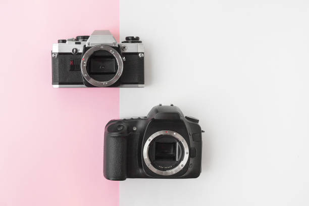 istock Digital versus Analog SLR Camera on Pink Background with Copyspace 1014672870