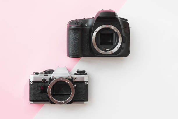 istock Concept - Digital vs. Analog SLR Camera on Pink Background 1014672910