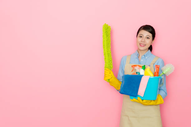 istock beauty female houseworker holding cleaning tool 1014676284