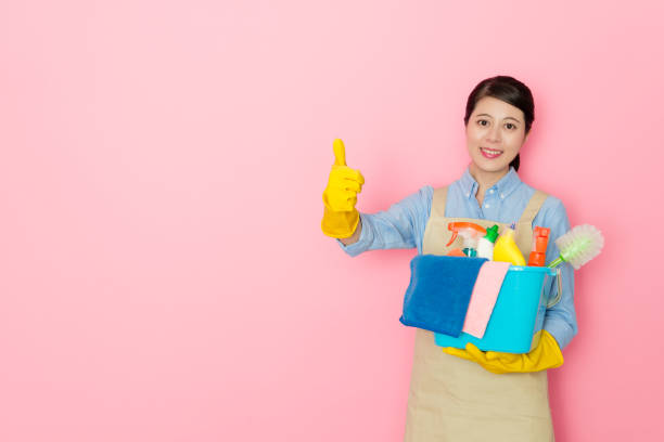 istock happy female housekeeper showing thumb up gesture 1014676610