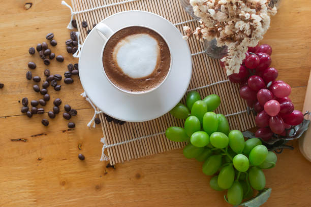 coffee in cup and coffee bean coffee in cup and coffee bean On the wooden table seramic stock pictures, royalty-free photos & images