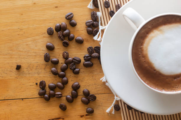 coffee in cup and coffee bean coffee in cup and coffee bean On the wooden table seramic stock pictures, royalty-free photos & images