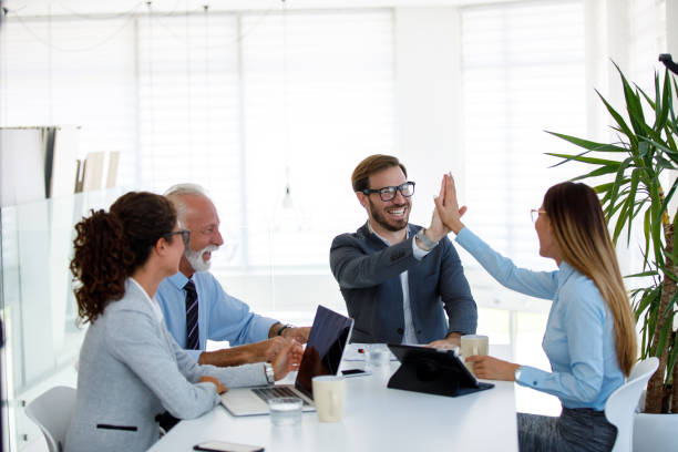 istock Business people giving a high five during meeting 1014681122