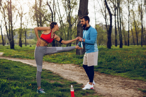 istock Fit athlete couple doing stretching exercises on running track 1014684968