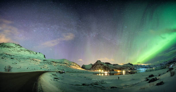 istock Aurora borealis with starry over mountain range on arctic coastline 1014686852