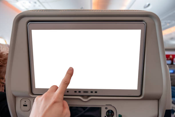 istock Hand touching on white display screen with joystick on rear seat in airplane 1014686892
