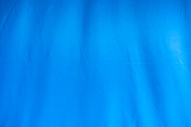 Horizontal studio shot of blue crushed velvet fabric background, slightly defocussed.